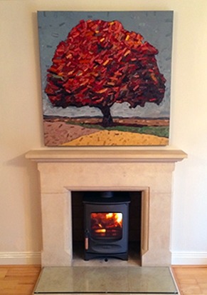 A stove set into a stone fireplace surround with a glass hearth, Cheltenham