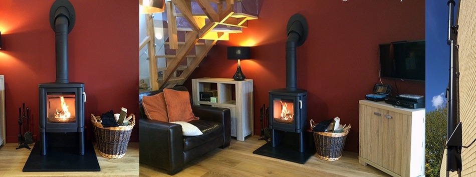 Two wood-burning stoves we installed in a room with deep red walls